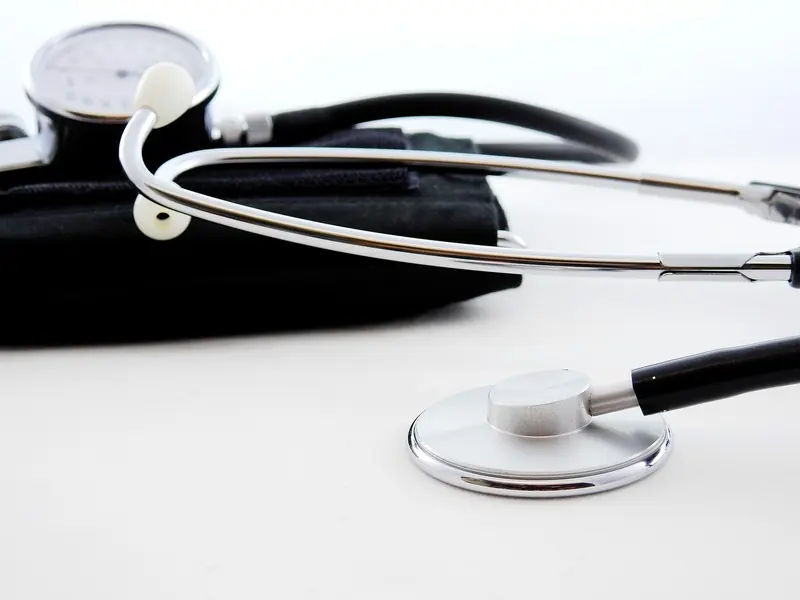 Stethoscope and blood pressure cuff on a white surface