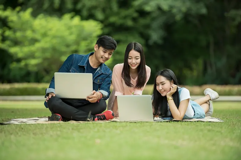 Students studying together on a lawn