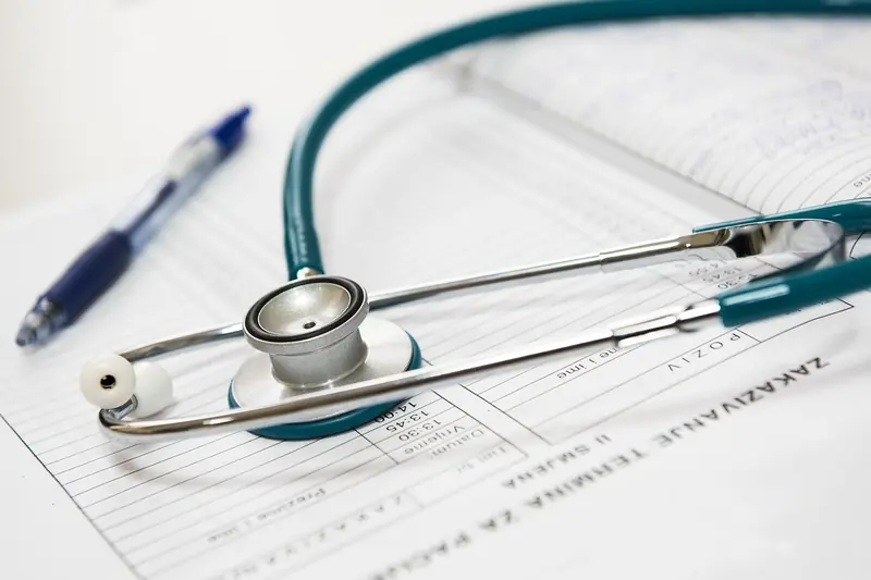 Stethoscope resting on medical forms