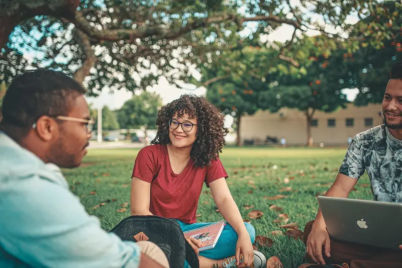 Students sitting together on a lawn
